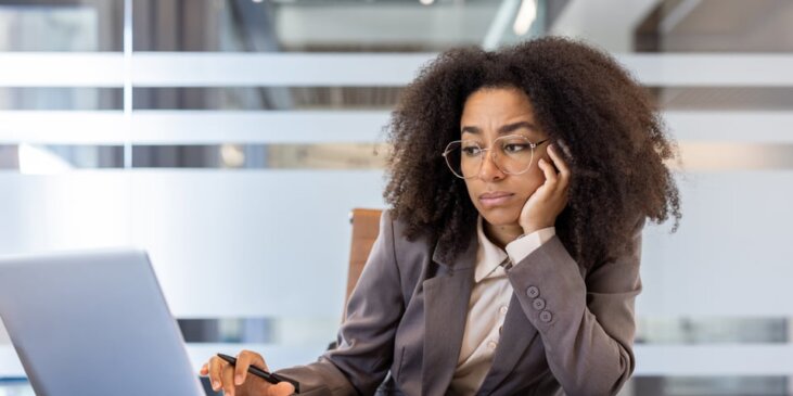 A woman operating a laptop in an office