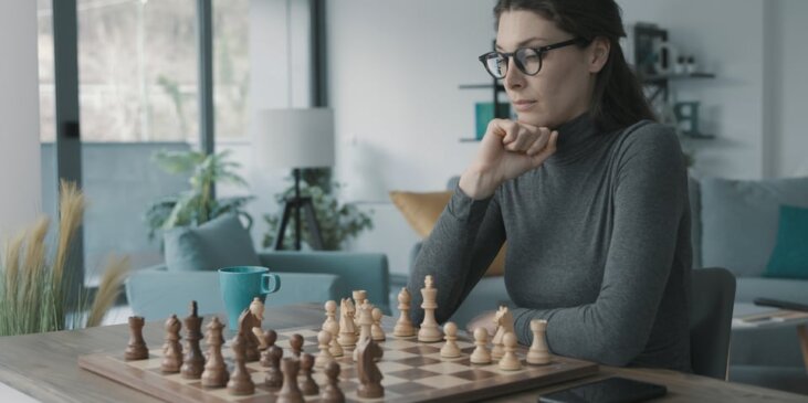 Woman intensely staring at a chessboard