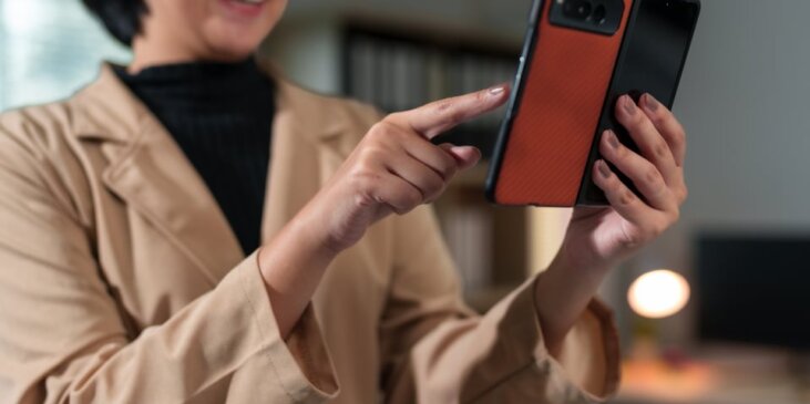 Smiling woman interacting with foldable phone